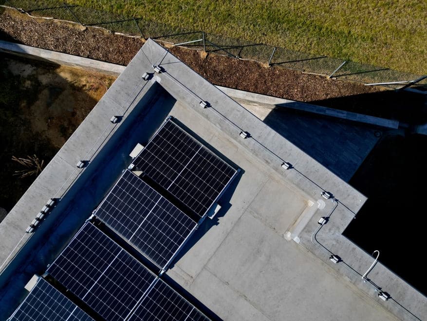 Vue aérienne de panneaux photovoltaïques installés sur toiture plate en béton avec membrane EPDM étanche