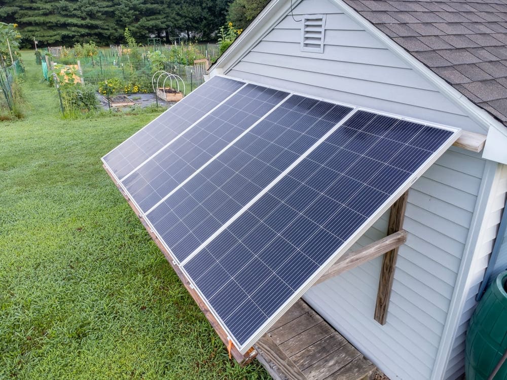 Panneaux solaires installés sur un abri de jardin pour alimenter une maison en autoconsommation
