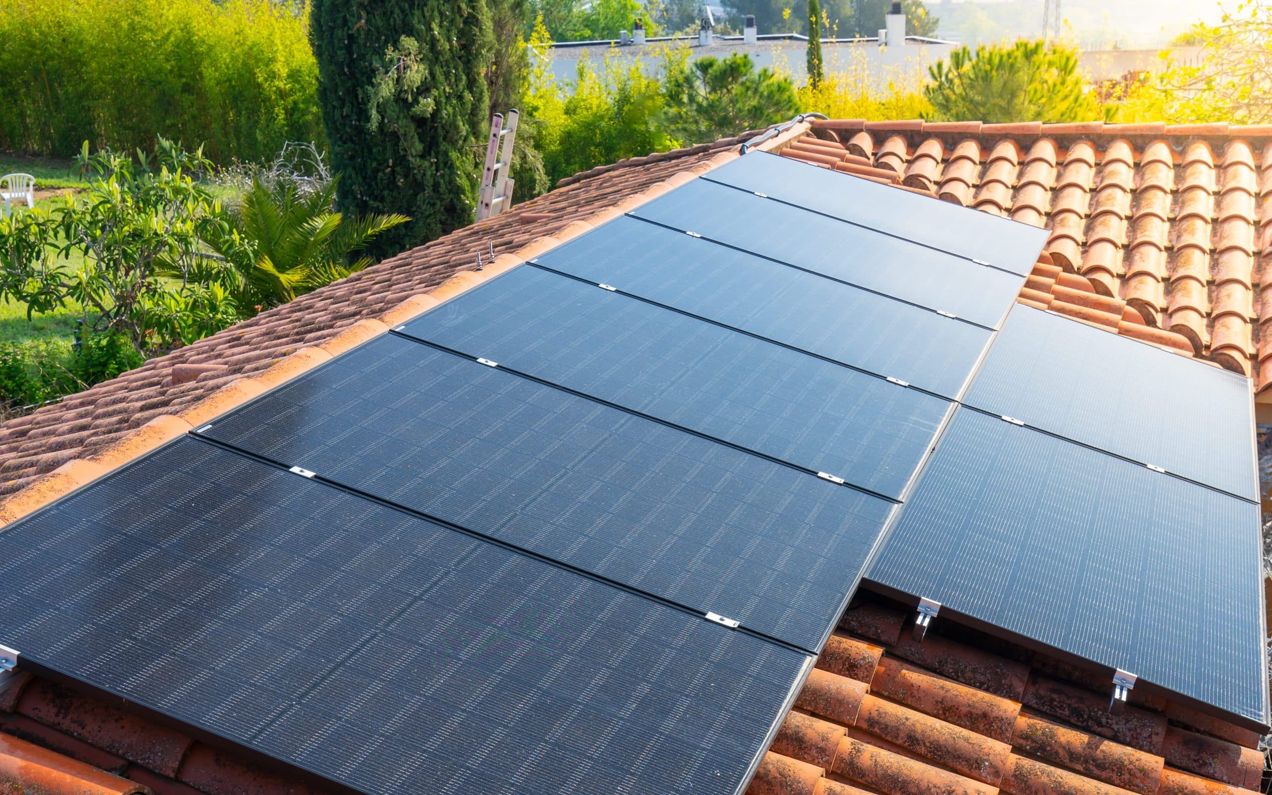 Panneaux solaires noirs en surimposition sur une toiture en tuiles provençales pour une installation plug and play en autoconsommation