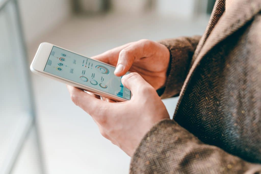 Personne consultant les données de production solaire sur une application smartphone compatible avec les micro-onduleurs TSUN ou Hoymiles