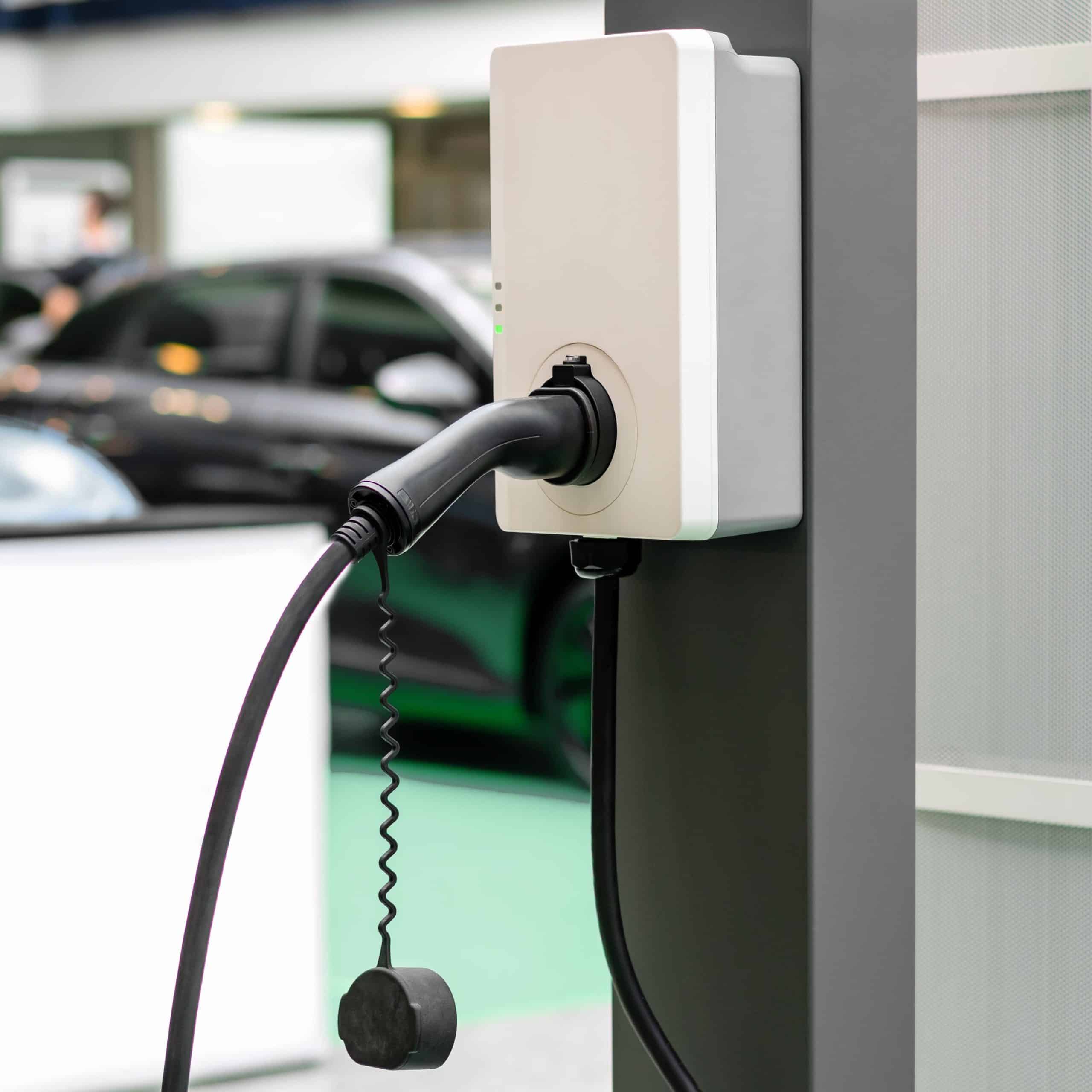 Borne de recharge murale pour voiture électrique installée dans un parking couvert
